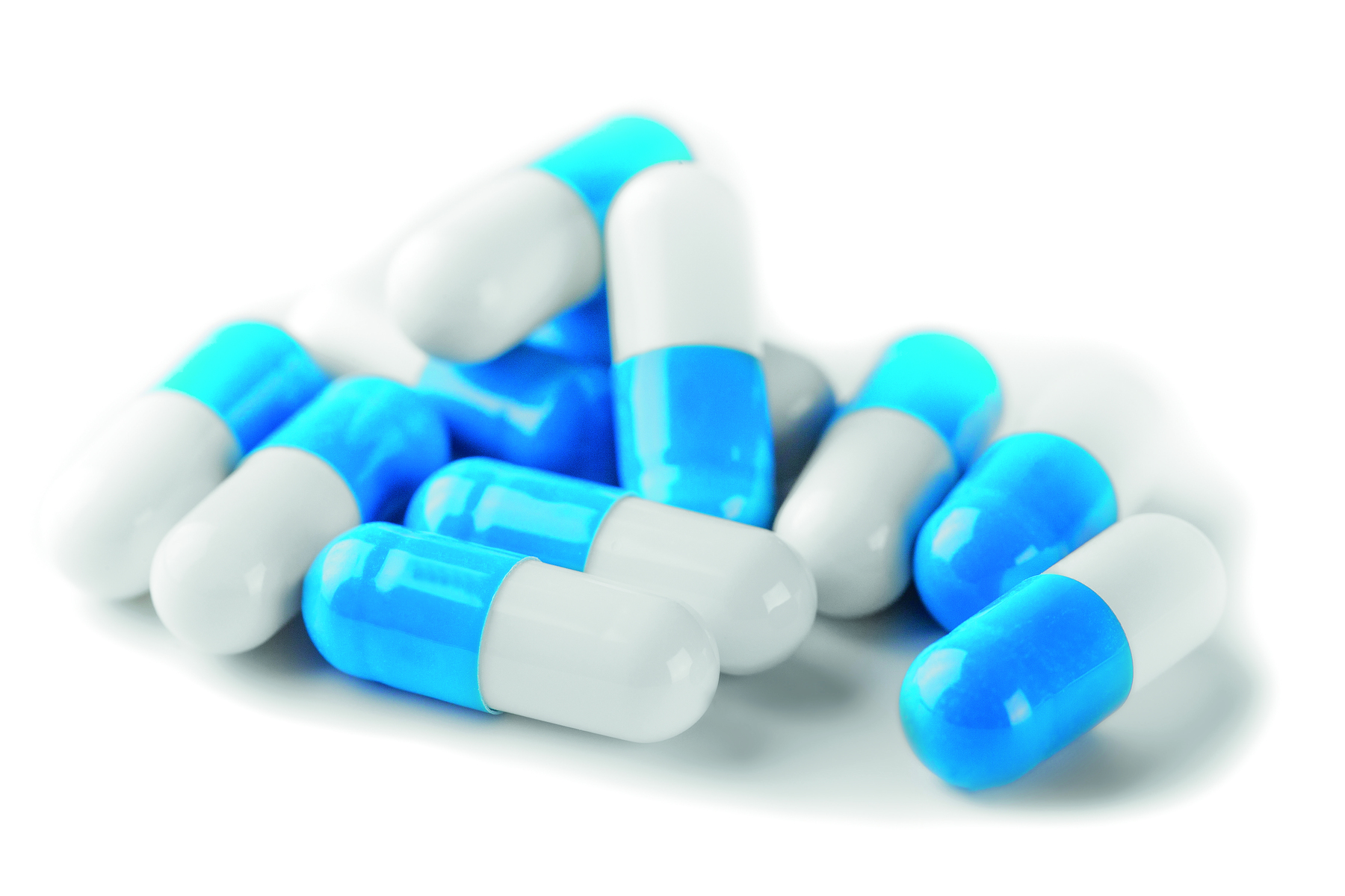 Fotografia de cápsulas de medicamento, com metade branca e metade azul.