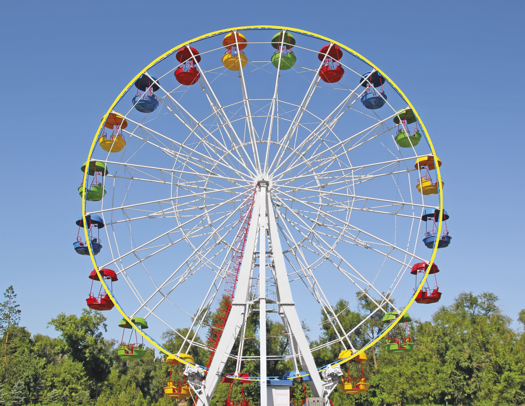 Fotografia. Roda-gigante com cabines coloridas. Ao fundo, árvores e o céu azul.