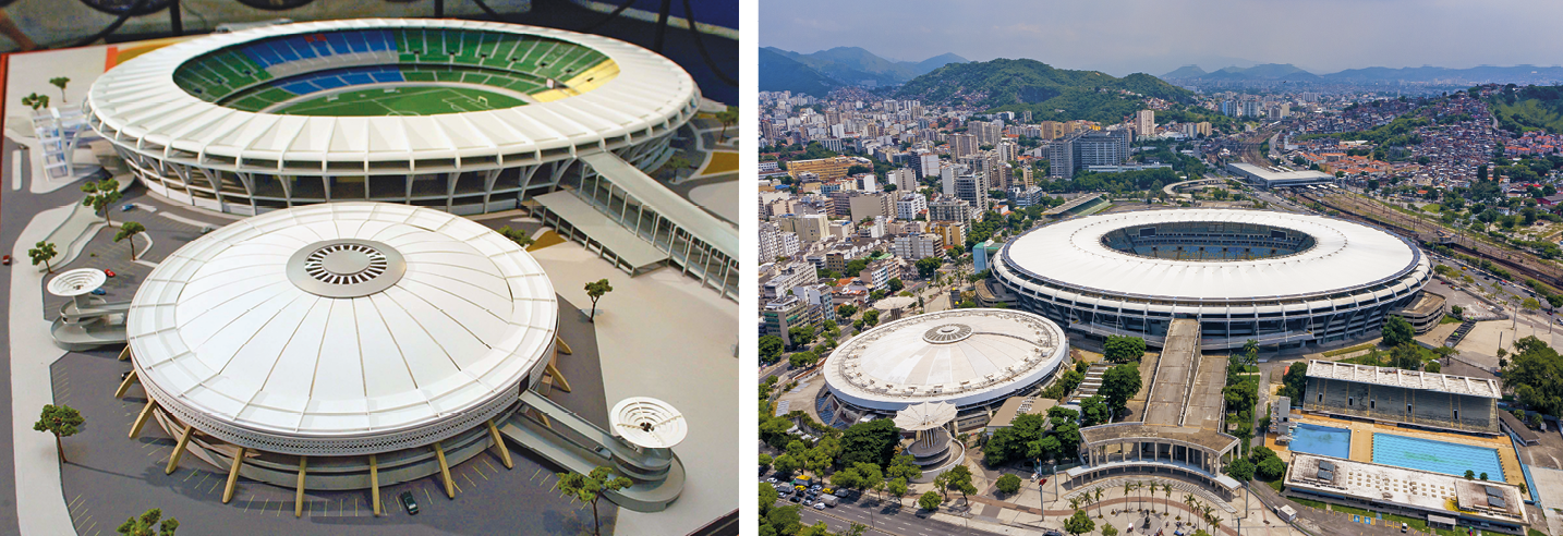 Fotografia. Miniatura do estádio de futebol, com formato circular e com cobertura na área da arquibancada que é colorida. É possível ver parte do campo. Ao lado, estádio de vôlei, com formato circular e teto fechado. Em volta, praça de circulação e acesso. Fotografia. Cidade com prédios e diferentes construções. No centro, estádio de futebol com formato circular e cobertura na área da arquibancada. Abaixo, do lado esquerdo, estádio de vôlei com formato circular e teto fechado. Do lado direito, duas piscinas com arquibancada coberta. Ao fundo, morros e céu azul.