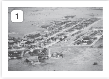 Imagem: Fotografia 1 em preto e branco. Vista geral de local solo deserto, com partes com árvores escuros e vegetação. Fim da imagem.