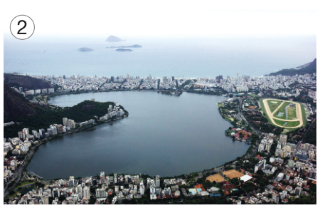 Imagem: Fotografia 2. Vista aérea de um lago com construções em volta. Fim da imagem.