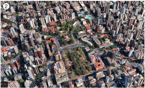 Imagem: Fotografia 2. Vista aérea de dois jardins retangulares e grandes com várias árvores. Em volta há ruas, várias casas e prédios.  Fim da imagem.
