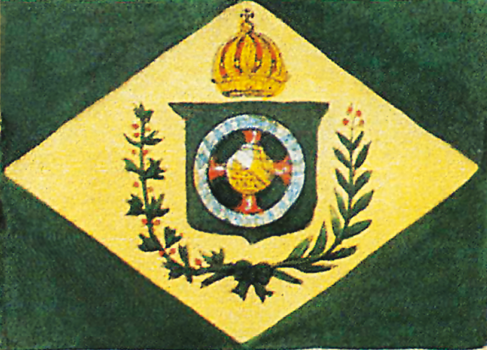Gravura. Bandeira formada por um retângulo verde, um losango amarelo, e ao centro, um brasão rodeado, à esquerda, por um ramo de café, e, à direita, por um ramo de tabaco. No topo do brasão há uma coroa.