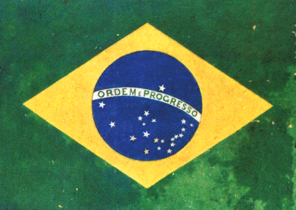 Pintura. Bandeira formada por um retângulo verde, um losango amarelo, um círculo azul, vinte e uma estrelas e uma faixa branca ao centro, escrito: Ordem e progresso.