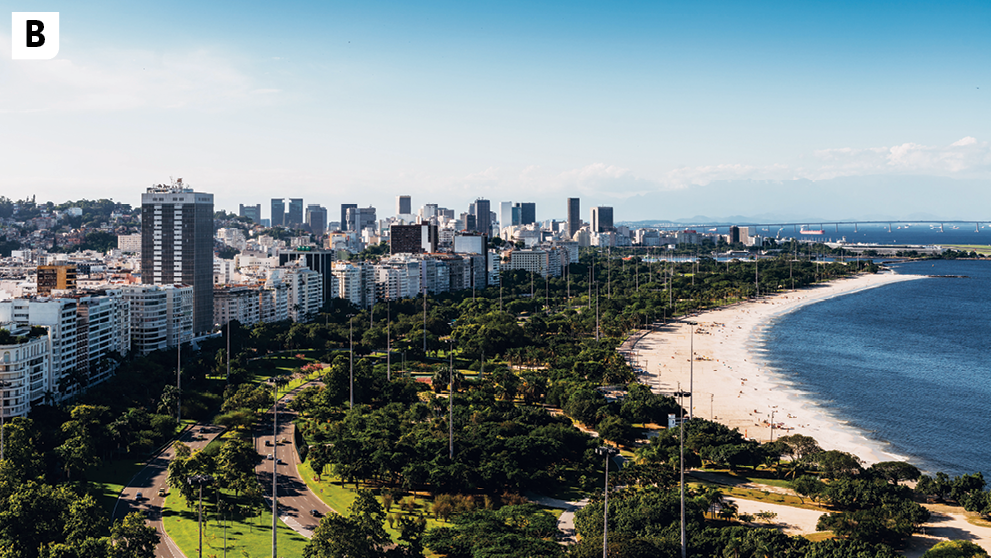 Fotografia B. Vista de uma praia com muitas árvores na sua orla. À esquerda da praia, diversas construções, destacando-se edifícios altos, com vários andares. À direita aparece o mar.