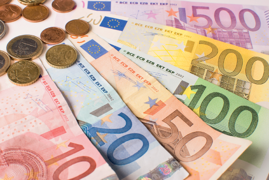 Fotografia. Notas de dinheiro nos valores de dez, vinte, cinquenta, cem, duzentos e quinhentos euros. E algumas moedas.