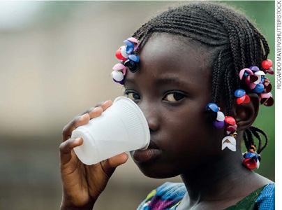 IMAGEM: garotinha bebendo água em um copo plástico. FIM DA IMAGEM.
