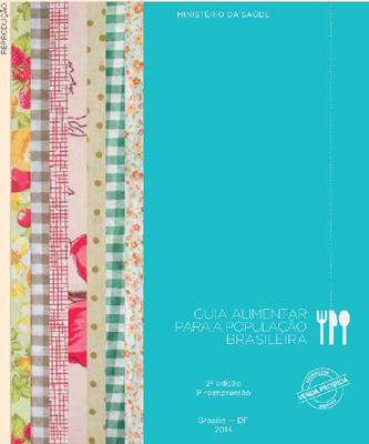 IMAGEM: capa do livro guia alimentar para a população brasileira. ao lado do título há a ilustração de um garfo, uma faca e uma colher. do lado esquerdo da imagem, há pedacinhos de toalhas de mesa enfeitadas, alinhados lado a lado. FIM DA IMAGEM.