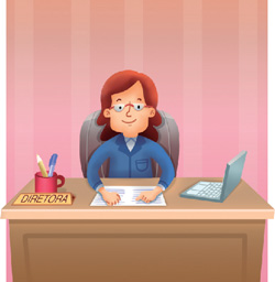 IMAGEM: uma mulher de óculos está sentada à mesa ao lado de um computador e de um porta-canetas. em cima da mesa há uma placa onde está escrito diretora. FIM DA IMAGEM.