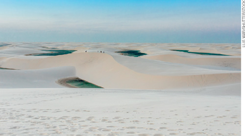 IMAGEM: dunas de areia clara, entre as quais a água da chuva forma lagoas. FIM DA IMAGEM.