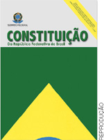 IMAGEM: capa da constituição brasileira em vigor, com parte da bandeira do brasil, com parte do retângulo verde, do losango amarelo e uma pequena porção do círculo azul. na parte superior, sobre o fundo branco, há o brasão da república federativa do brasil e o título. FIM DA IMAGEM.