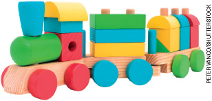 IMAGEM: trem de brinquedo colorido, montado com peças sólidas de formatos geométricos variados. FIM DA IMAGEM.