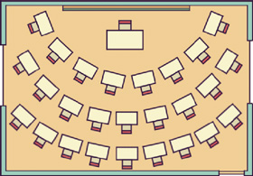 IMAGEM: vista de cima de uma sala de aula, com a mesa do professor no centro, a lousa atrás e as carteiras dispostas em um semicírculo. FIM DA IMAGEM.