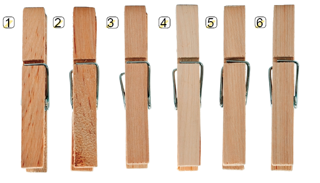 Imagem: Fotografia. Seis pregadores de madeira em tons de marrom com números ao lado. Fim da imagem.
