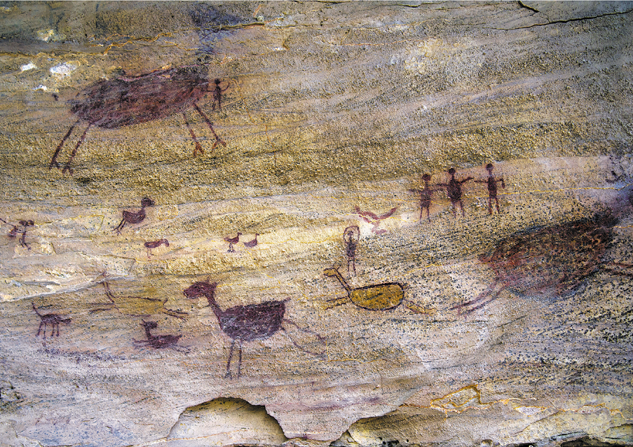 Imagem: Fotografia. Pinturas rupestres em uma pedra com formatos de animais e pessoas. Fim da imagem.