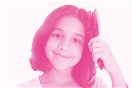 Imagem: Fotografia em tons de rosa. Menina de cabelo curto, sorrindo. Está penteando o cabelo. Fim da imagem.