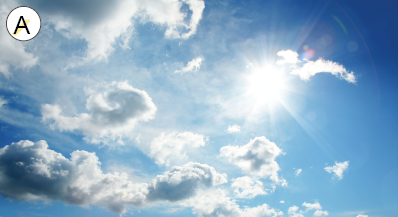 Imagem: Fotografia. A: Céu azul com sol e nuvens brancas. Fim da imagem.