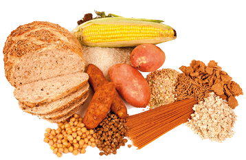 Imagem: Fotografia. Alimentos diversos como pão, grãos, macarrão, batatas e milho. Fim da imagem.