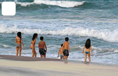 Imagem: Fotografia. Crianças brincando na areia da praia.   Fim da imagem.