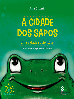 Imagem: Ilustração. Capa de livro. Na parte superior, o título: a cidade dos sapos. No centro, desenho de um sapo sorrindo.  Fim da imagem.