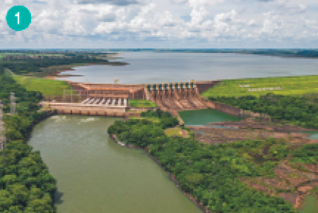 Imagem: Fotografia. Uma barragem com vegetação dos lados. Fim da imagem.