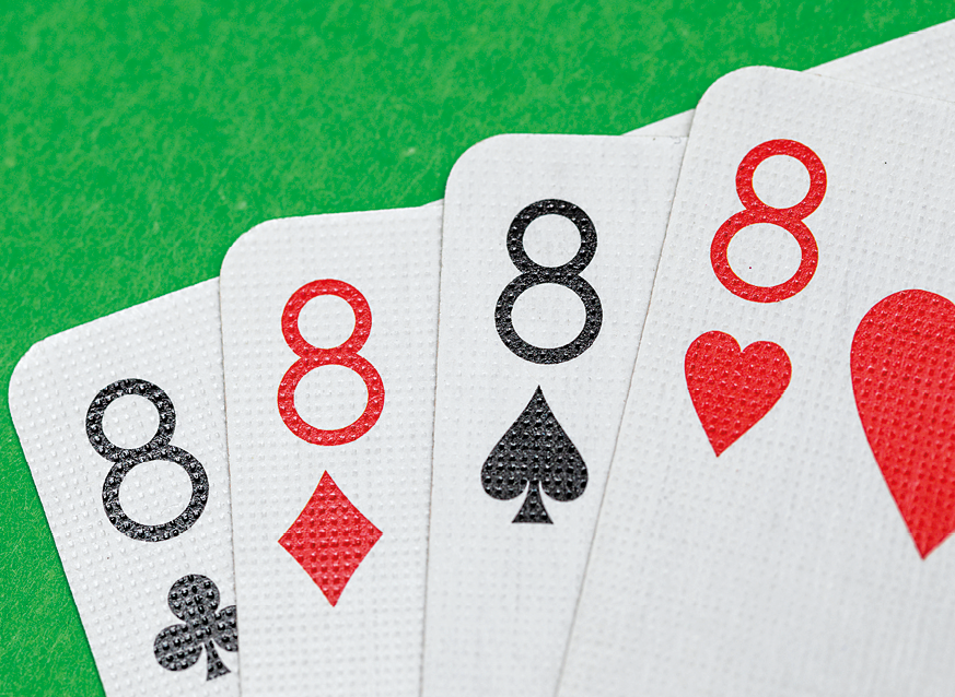Fotografia. Vista parcial de cartas de baralho em preto e vermelho do numero 8 com naipe de paus, ouros, espadas e copas.