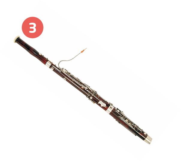 Fotografia número 3. Instrumento de sopro cilíndrico comprido, fino e com chaves ao longo do corpo e um tubo pequeno em uma das extremidades.