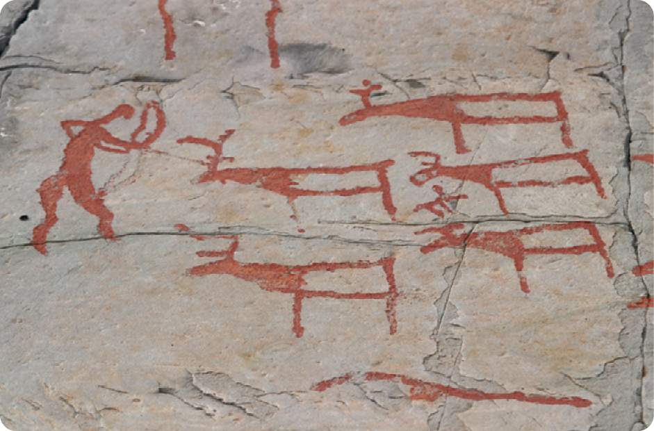 Pintura rupestre. À esquerda, silhueta de uma pessoa segurando arco e flecha com as mãos. Ao lado, silhuetas de animais quadrúpedes.