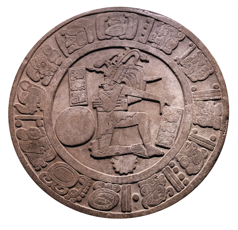 Relevo. Forma circular, com detalhes em relevo de uma pessoa, ao lado uma bola. Ao redor símbolos do calendário maia.