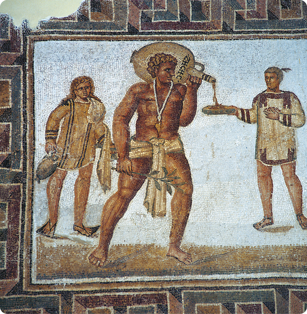 Mosaico. À esquerda, um homem, com tecido ao redor da cintura, está de pé, apoiando um barril sobre o ombro e inclinando-o na direção de uma tigela que é segurada por um homem, usando uma roupa com mangas compridas. Atrás, um homem de pé carregando com as mãos alguns objetos.