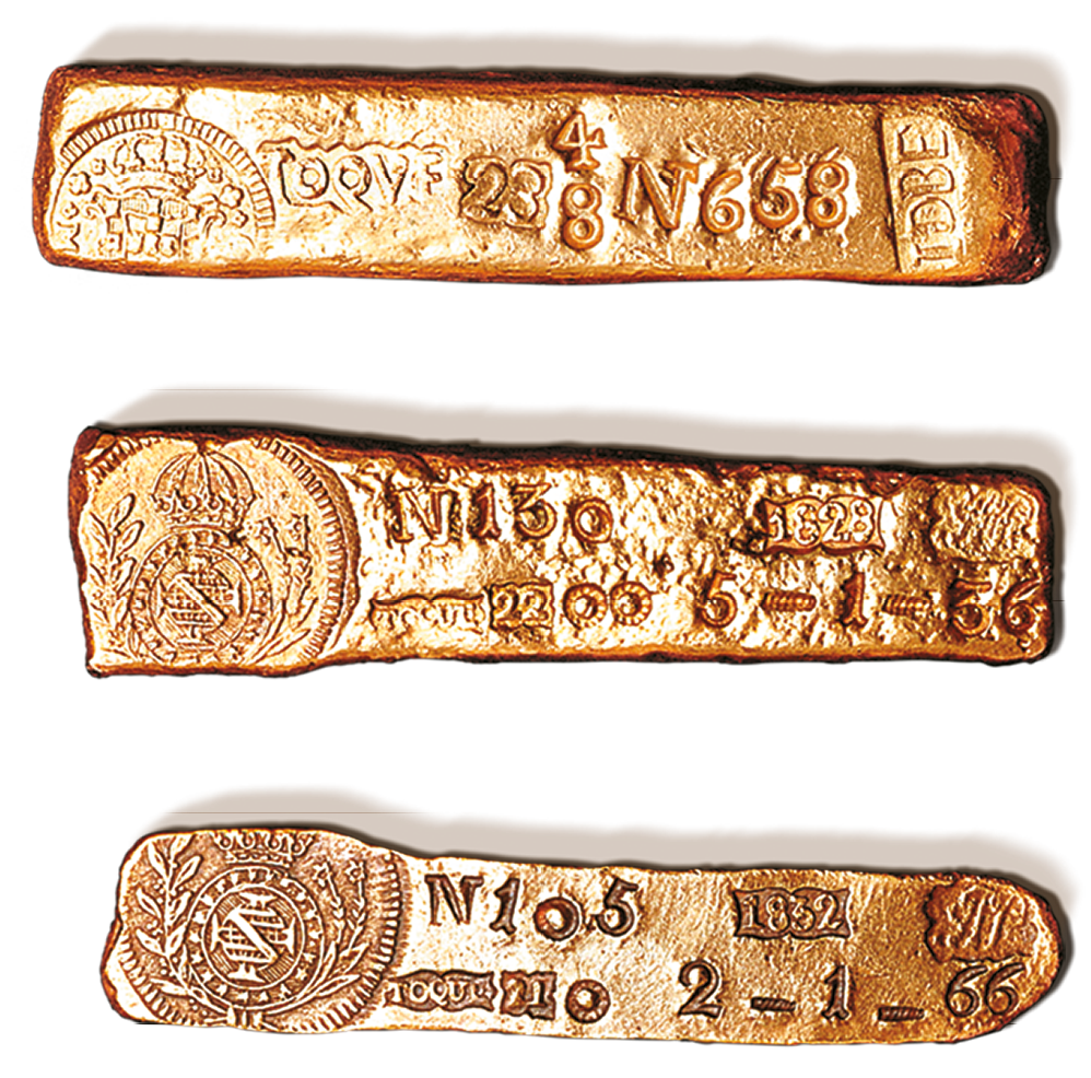 Fotografia. Três barras de ouro com detalhes em relevo de brasões e números.