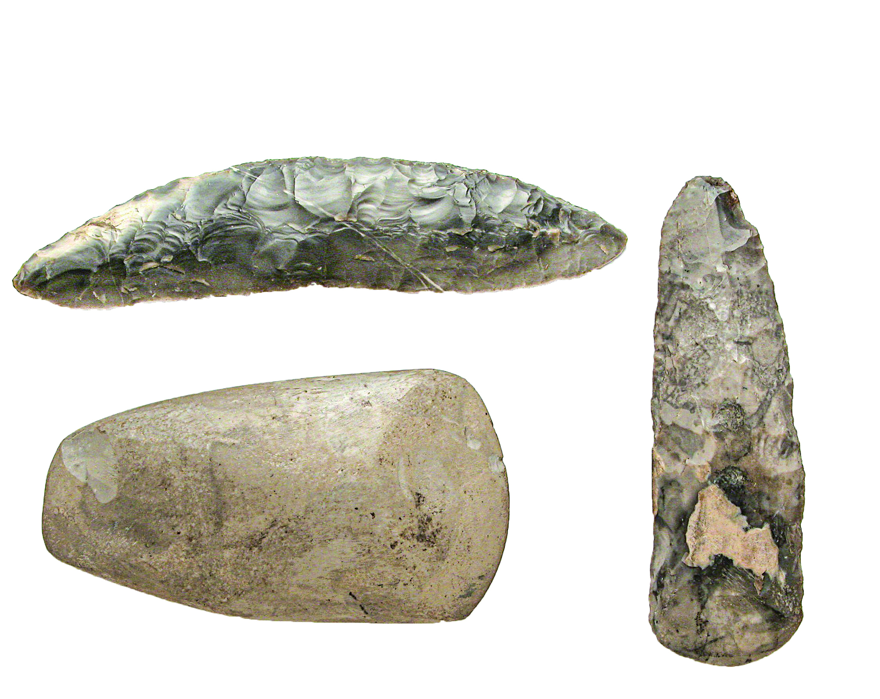 Fotografia. Três artefatos de pedra de superfície lisa e arredondada.