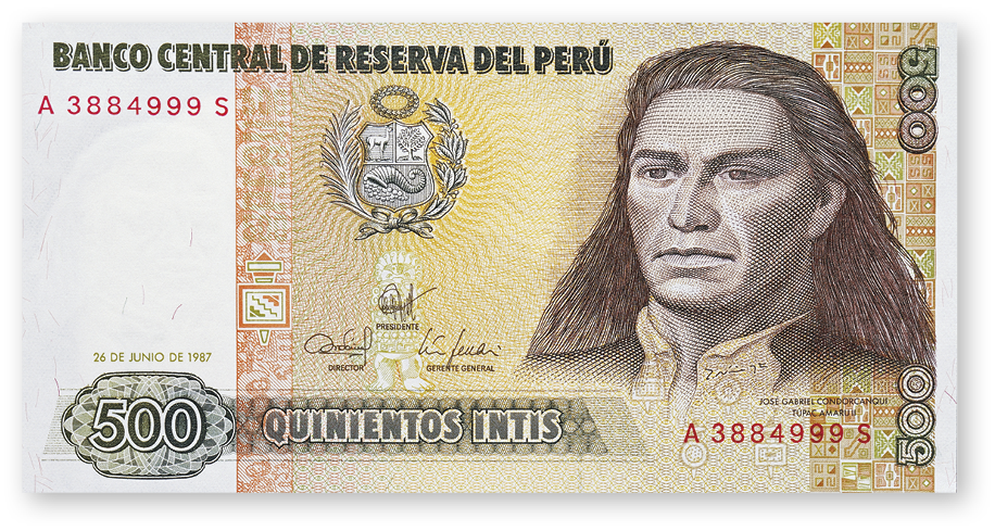 Fotografia. Cédula de dinheiro com a imagem, no canto direito, de um homem indígena com cabelos compridos e um brasão no centro. No canto inferior esquerdo o valor, 500 intis.