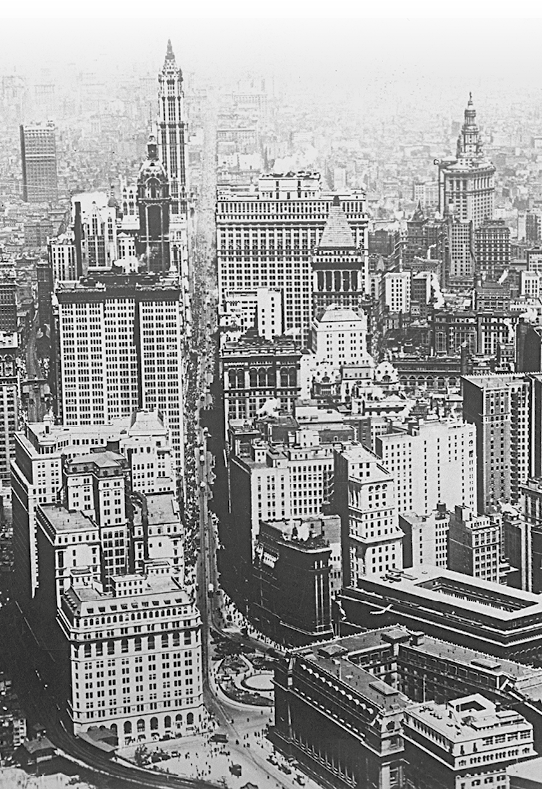 Fotografia em preto e branco. Vista aérea de área da cidade formada por grandes prédios.